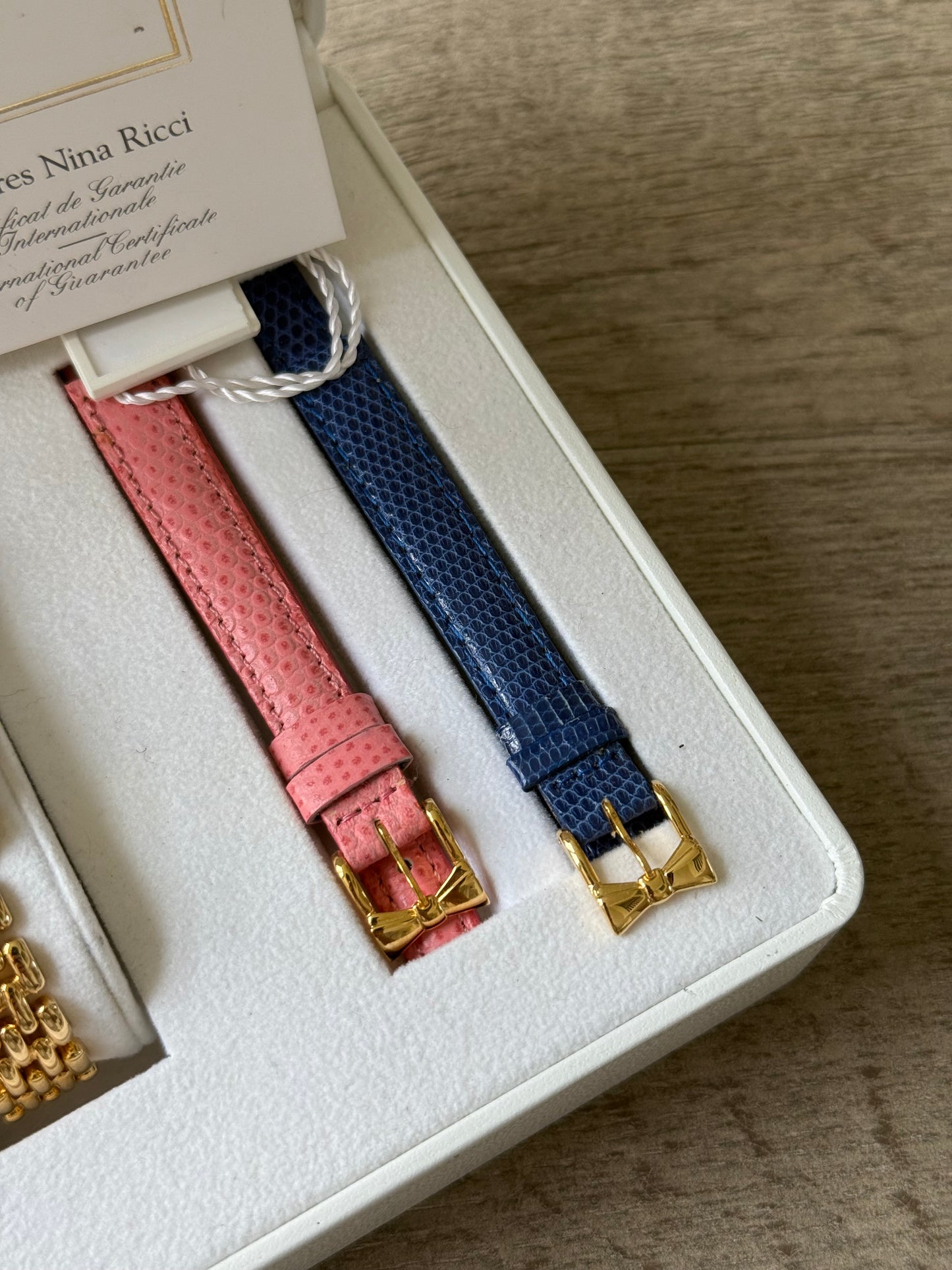 Nina Ricci Gold Toned Watch with Bow Bezel Set