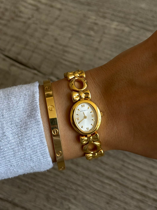 Nina Ricci Gold Toned Watch with Bow Band